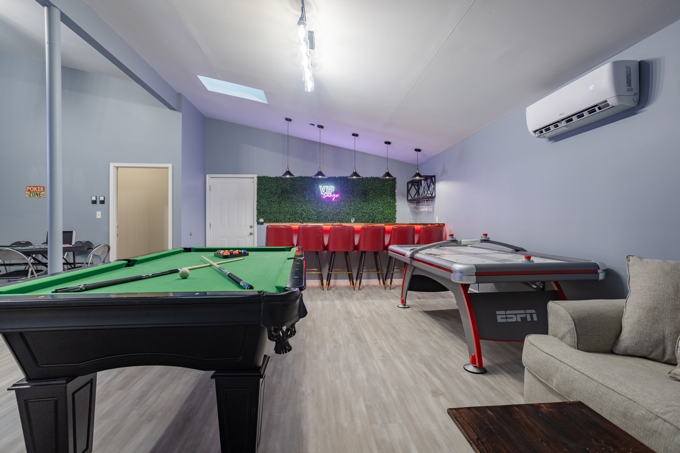 Aurora Abodes entertainment room with game tables